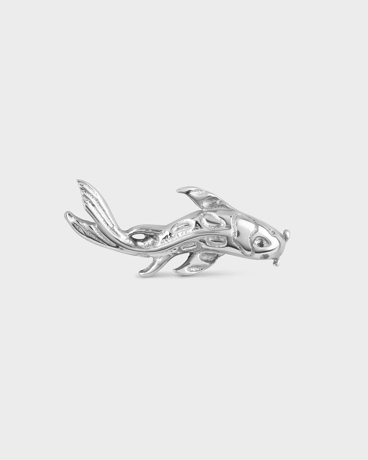 White gold koi-shaped earring on a light gray background
