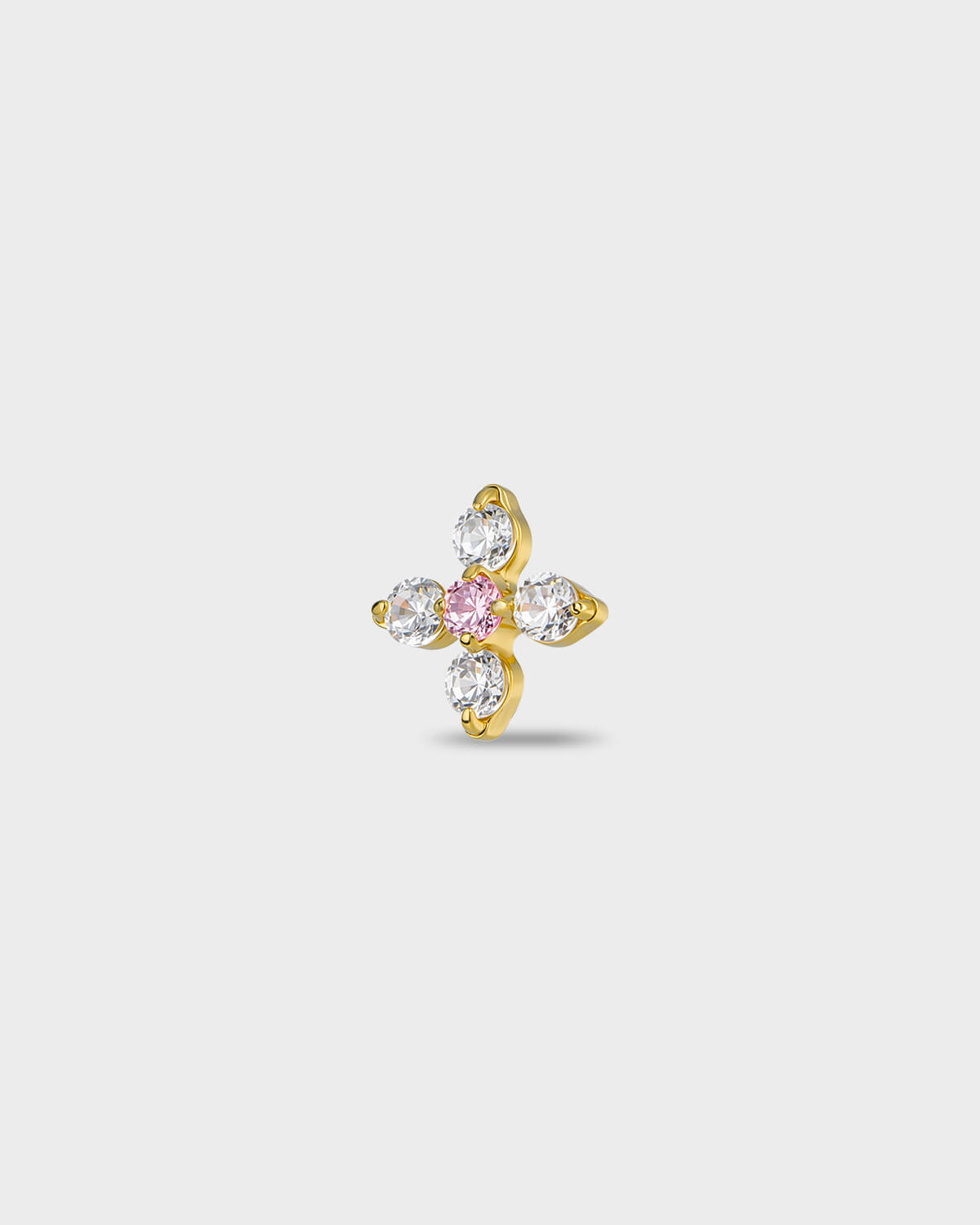 Gold titanium earring with four round-cut clear stones set around a single round-cut pale pink stone, on a light gray background.