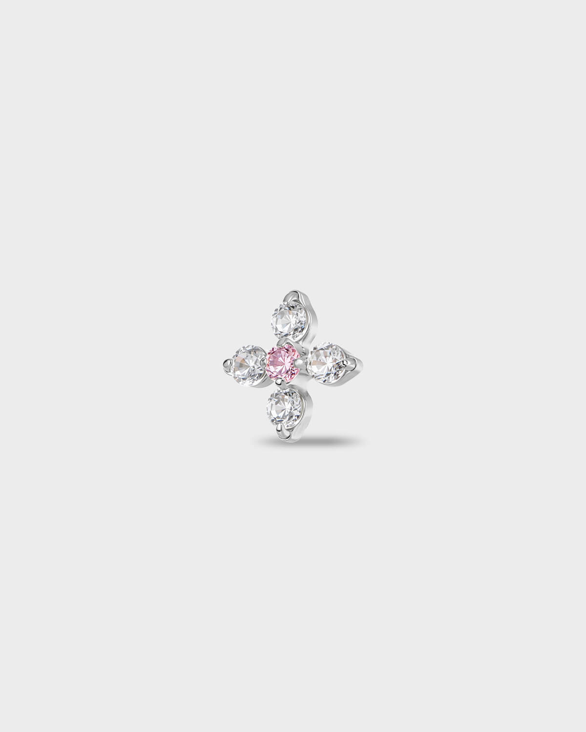 Polished titanium earring with four round-cut clear stones set around a single round-cut pale pink stone, on a light gray background.