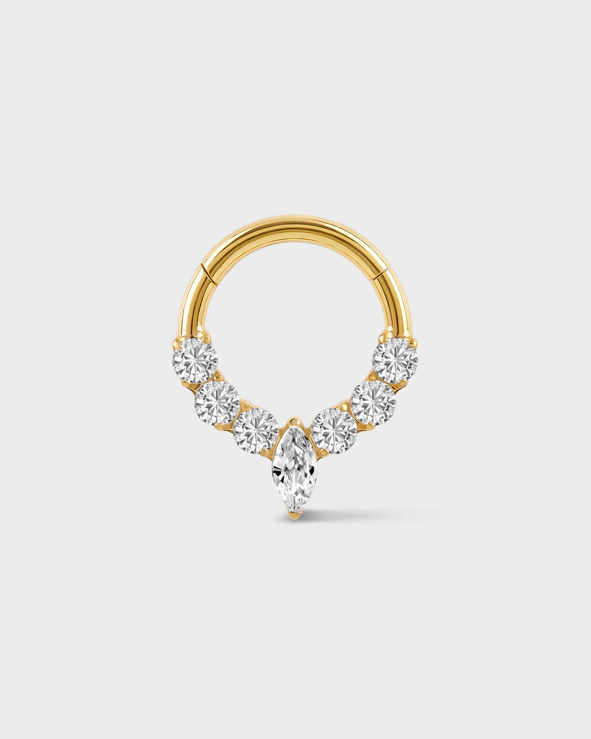 Gold daith ring with central marquise gemstone and three gem either side on a light gray background
