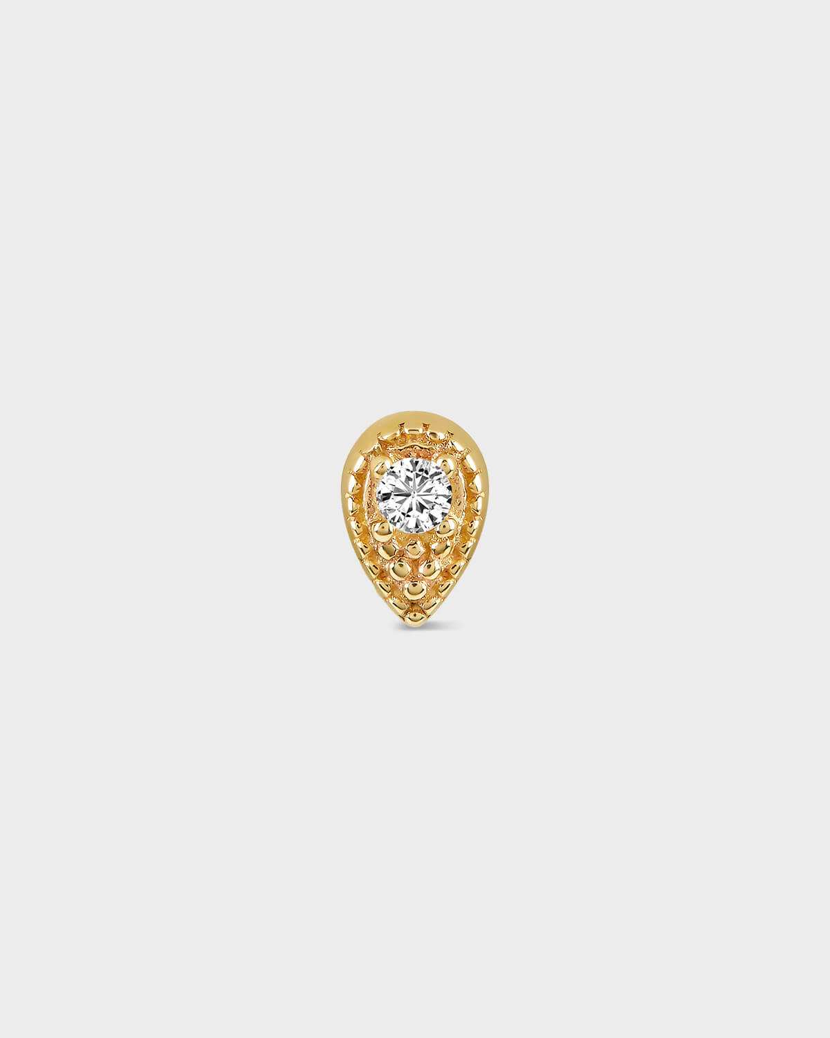Gold teardrop-shaped earring with a diamond on a light gray background