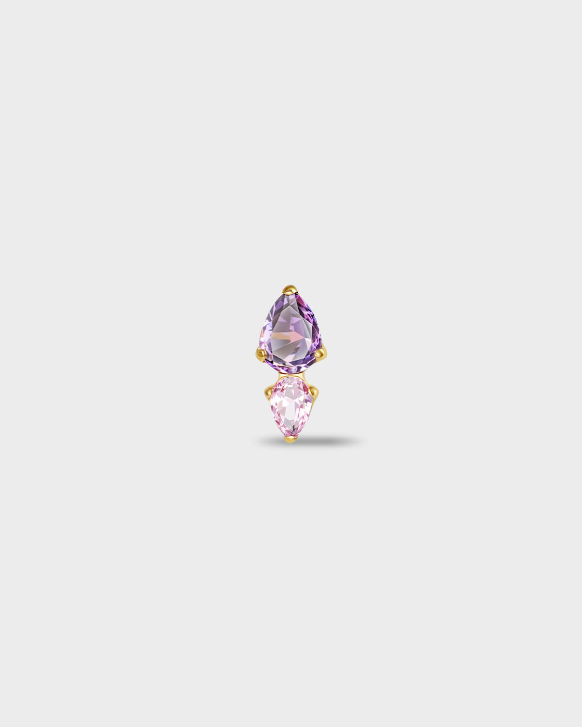 Gold titanium earring with a pear-cut purple stone set above a smaller pear-cut pale pink stone on a light gray background.