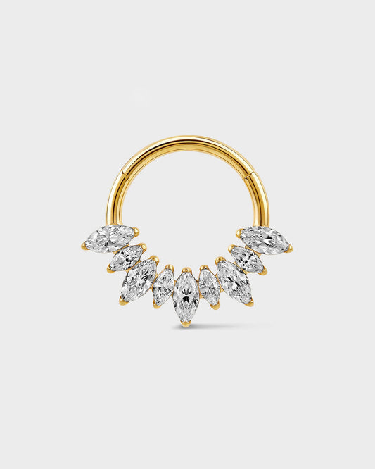 Gold titanium daith ring with alternating graduated marquise gemstones on a light gray background.