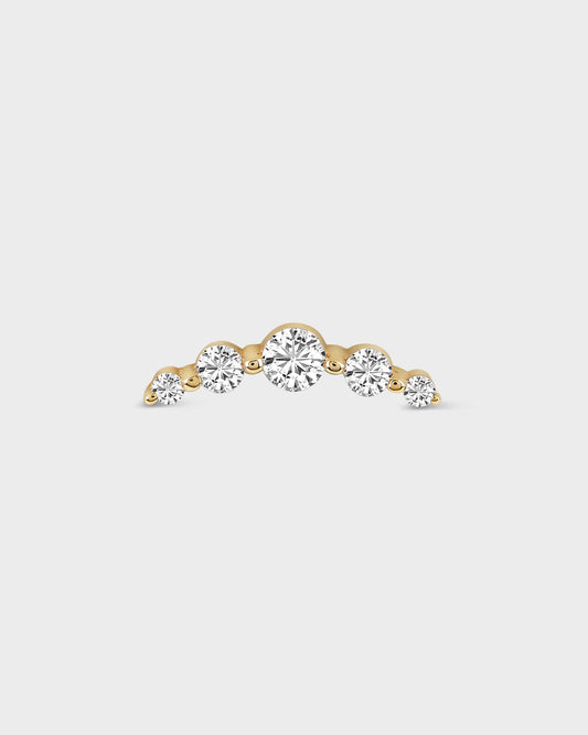 Gold earring with three clear gemstones on a light gray background