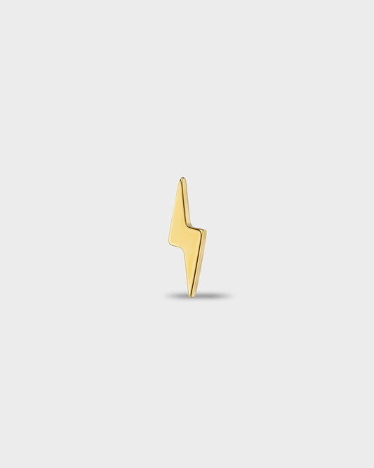 Gold titanium earring with a polished lightning bolt shape, on a light gray background.
