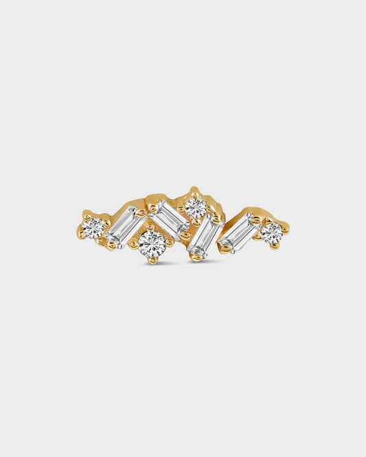 Gold and diamond earring on a light gray background