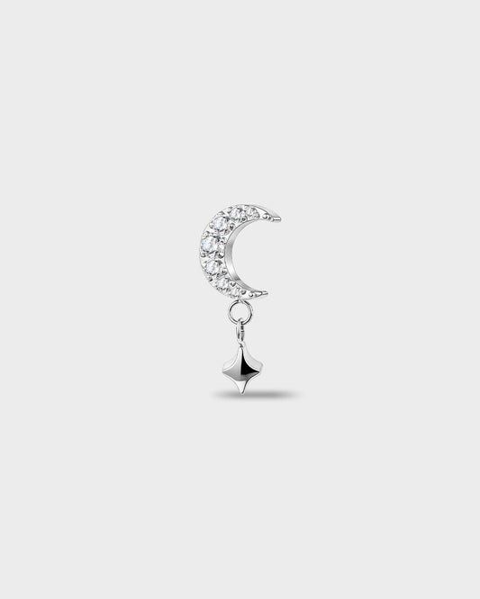 Polished silver titanium earring with a crescent shape set with clear round stones and a short dangle star detail on a light gray background.