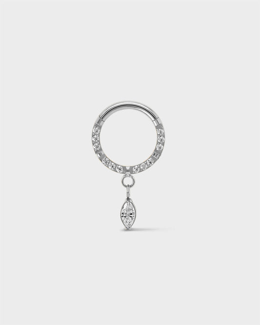 Semi pave polished silver titanium daith septum ring with a marquise dangle charm sat on a light gray background.