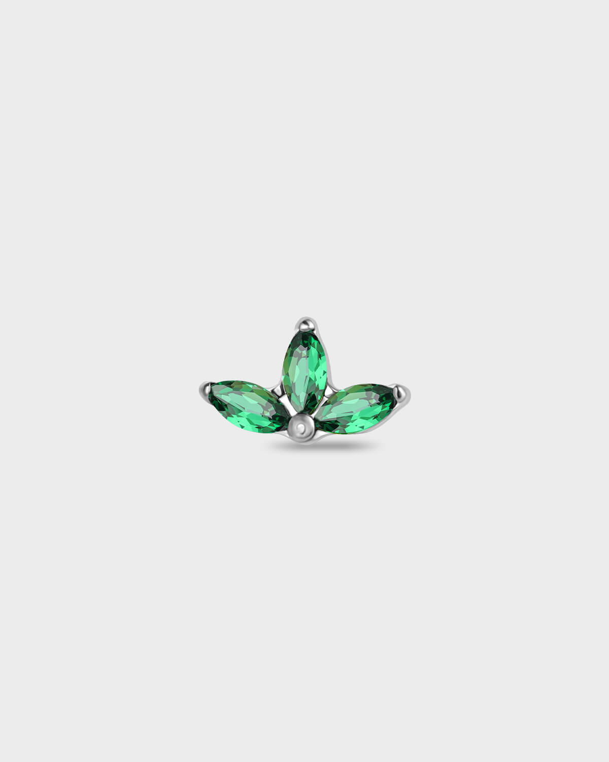 Polished titanium earring with three emerald green marquise gemstones on a light gray background