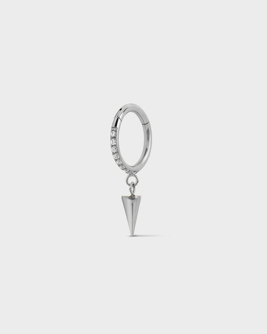 Polished silver titanium hinged ring with pave gems around the outer edge and a single cone dangle charm sat on a light gray background.