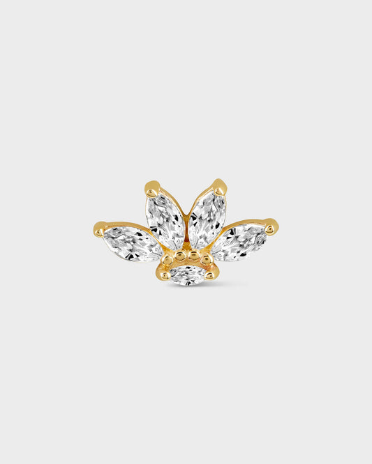Shaped earring with clear gemstones on a light gray background
