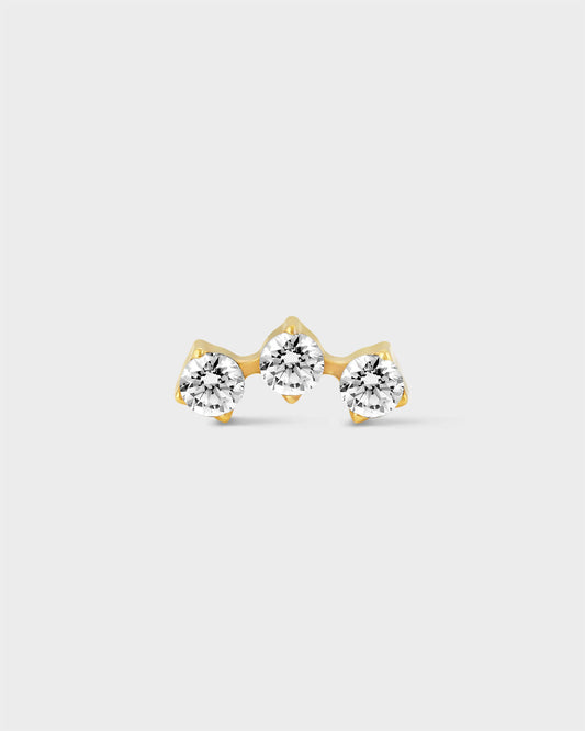 Delicate gold titanium earring with 3 gemstones in an arc formation on a light grey background