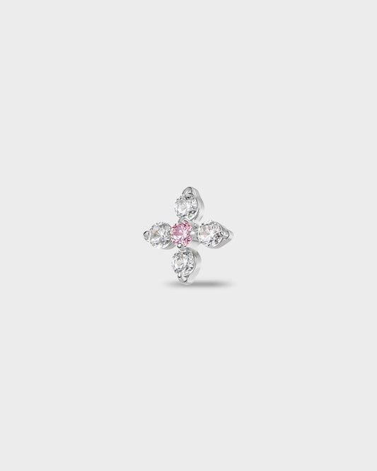 Polished titanium earring with four round-cut clear stones set around a single round-cut pale pink stone, on a light gray background.