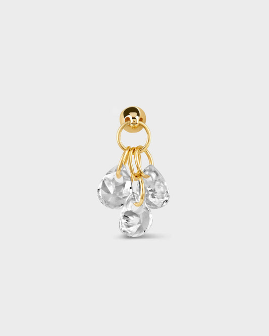 Gold earring with clear gemstones on a white background