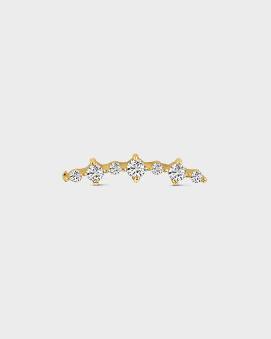 Gold earring with diamonds on a light gray background