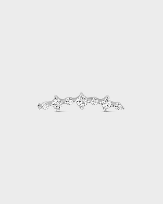 Silver earring with multiple diamonds on a light gray background