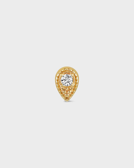 Gold teardrop-shaped earring with a diamond on a light gray background