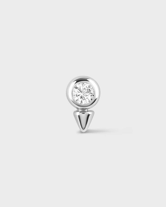 White gold earring with a clear gemstone on a light gray background
