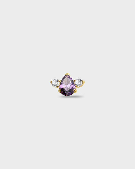 Gold titanium earring with a pear-cut purple stone set between two round-cut clear stones on a light gray background.