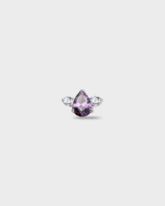 Polished titanium earring with a pear-cut purple stone set between two round-cut clear stones on a light gray background.