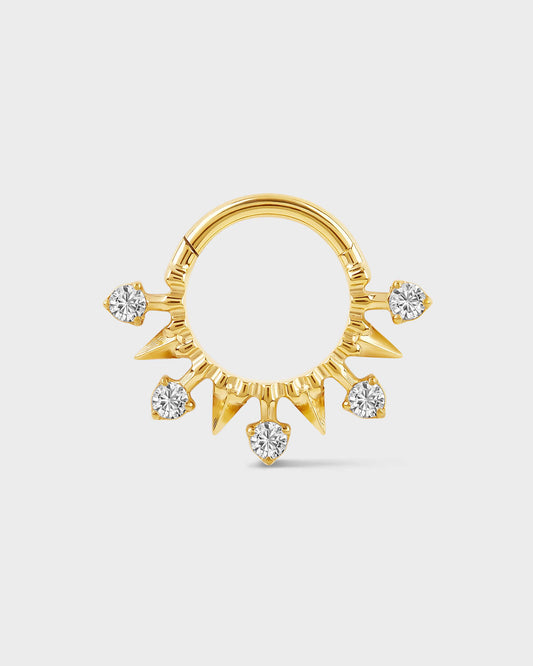 Gol titanium daith or septum ring with alternating spikes and solitaires on a light gray background.