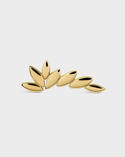 Gold wing shaped earring on a light gray background