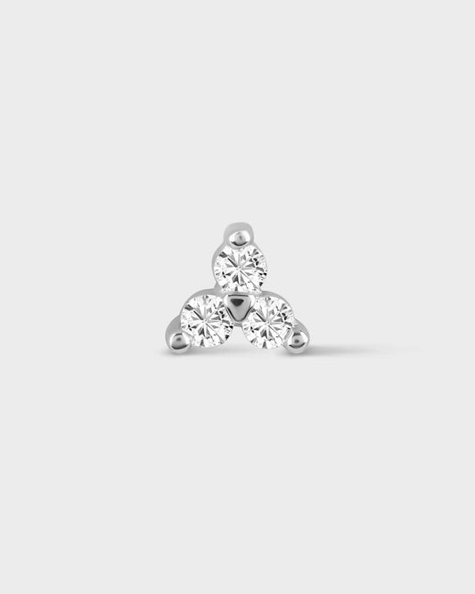 White gold earring with three clear gemstones on a light gray background