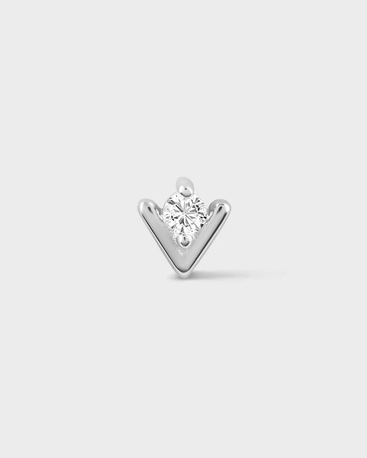 White gold earring with a clear gemstone on a light gray background